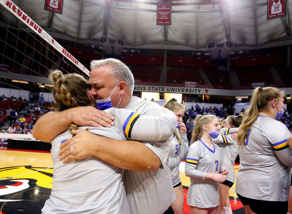 November 13, 2021 - Normal, Illinois -  
Southeastern head coach Larry Kerr hugs his daughter Ani after their title match against St. Thomas More for the Class 1A championship trophy at the IHSA Volleyball State Finals. Finishing second in the state, the Lady Suns fell to St. Thomas More, 22-25, 25-18, 25-17.  (Photo: PhotoNews Media/Clark Brooks)