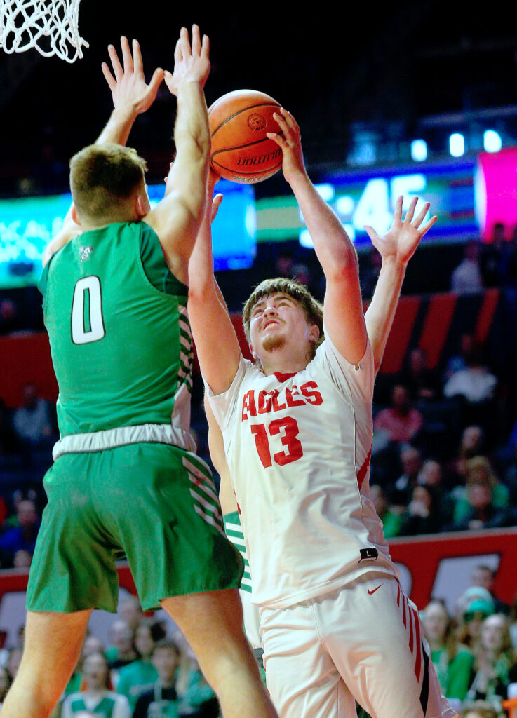 March 10, 2022 - Champaign, Illinois - Liberty's Breiton Klingele takes a shot over Scales Mound's Zayden Ellsworth during their state semifinal game at the IHSA Boys Basketball State Finals on Thursday. The Eagles defeated to the Hornets, 75-41.(Photo: PhotoNews Media/Clark Brooks)