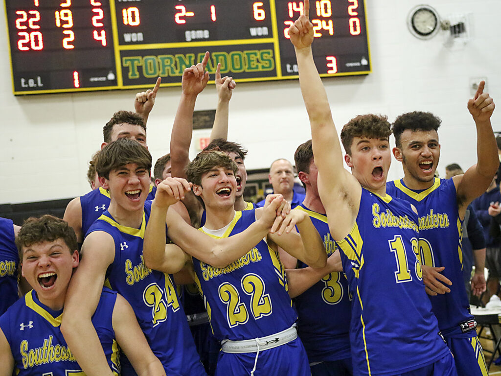 Members of the Southeastern basketball team celebrate the presentation of the championship plaque following the Suns' 45-34 victory over the Chargers in the Class 1A Sectional title game on Friday, March 4, 2022 at Abingdon-Avon High School's Dunlap Gymnasium.