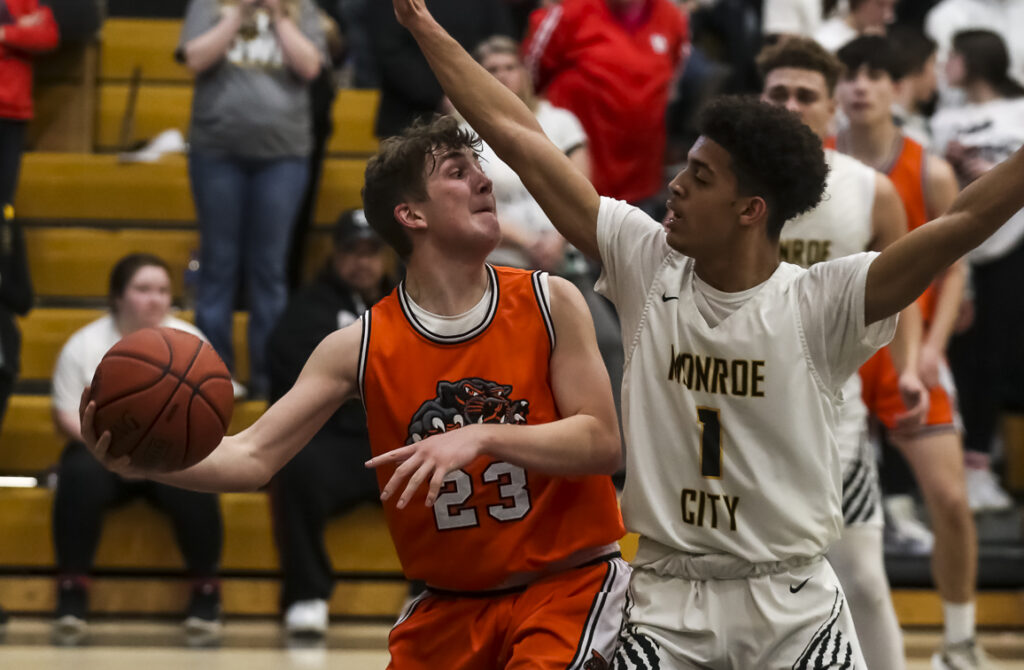 Alex Loman (23) passes the ball around Josiah Tolton (1) during the game between Palmyra and Monroe City Tuesday in Monroe City.  Mathew Kirby/Herald Whig-Courier Post