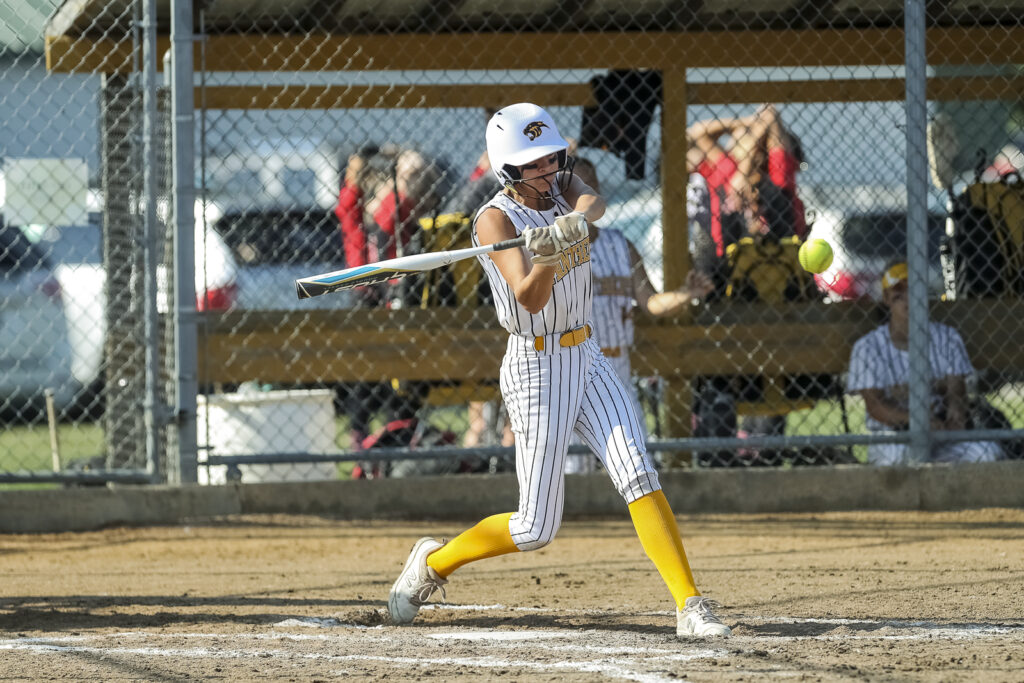 Monroe City’ Audri Youngblood (9) hits a triple, during the Panthers game against the Pirates in Monroe City tournament, Saturday.  Mathew Kirby/Herald Whig-Courier Post