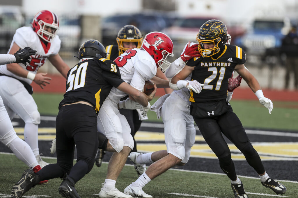 Monroe City’s Gabriel Creel (50) tackles Lincoln’s Ross Johnson (33) during the Panthers quarterfinal game against the Cardinals, Saturday in Monroe City.  Mathew Kirby/Herald Whig-Courier Post
