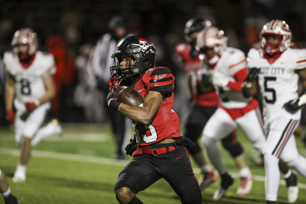 Hannibal senior running back Marshal Humphrey (33) runs by everyone for a touchdown during the Pirates district championship game against Jefferson City, Friday in Hannibal.  Mathew Kirby/Herald Whig-Courier Post