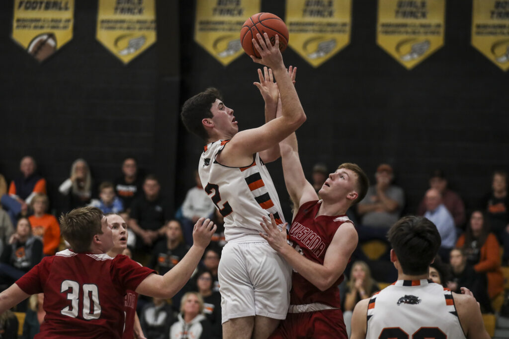 Palmyra’s Bear Bock (2) shoots over a defender during the Panther’s semifinal game against Louisiana in the of the 98th Annual Monroe City basketball tournament.  Mathew Kirby/herald Whig-Courier Post