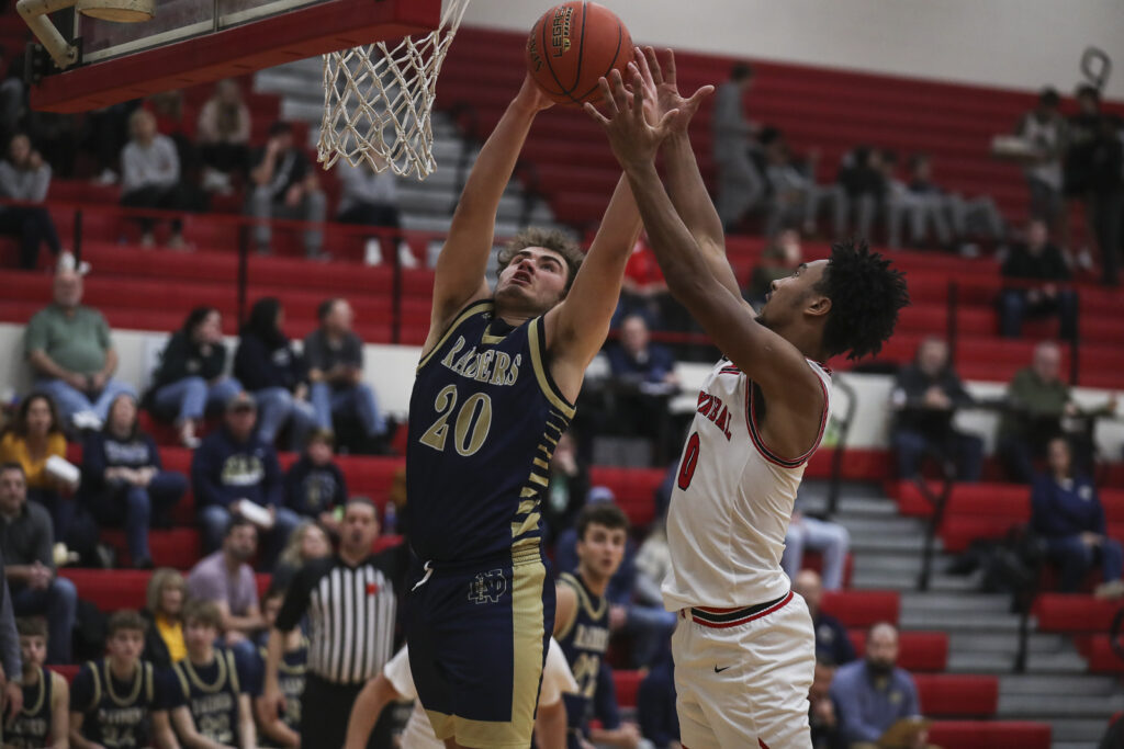 Hannibal’s Haden Robertson (0) and QND’s Josh Locke (2) battle for a rebound during the Pirates and QND game, Saturday in Hannibal.  Mathew Kirby/Herald Whig-Courier Post