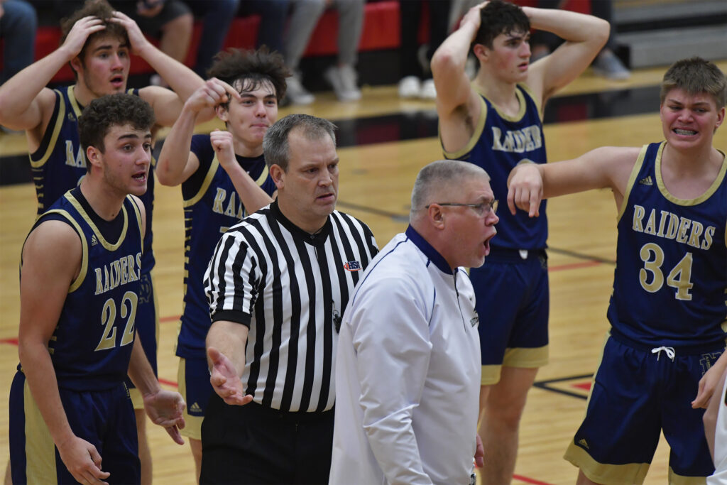 Quincy Notre Dame players and head coach Kevin Meyer react after the official ruled a last-second basket by guard Jake Hoyt did not count. Quincy Notre Dame played Highland at the Highland Optimist Scott Credit Union Shootout at Highland High School in Highland, IL on Saturday January 7, 2023.  
Photo Courtesy Tim Vizer Photography