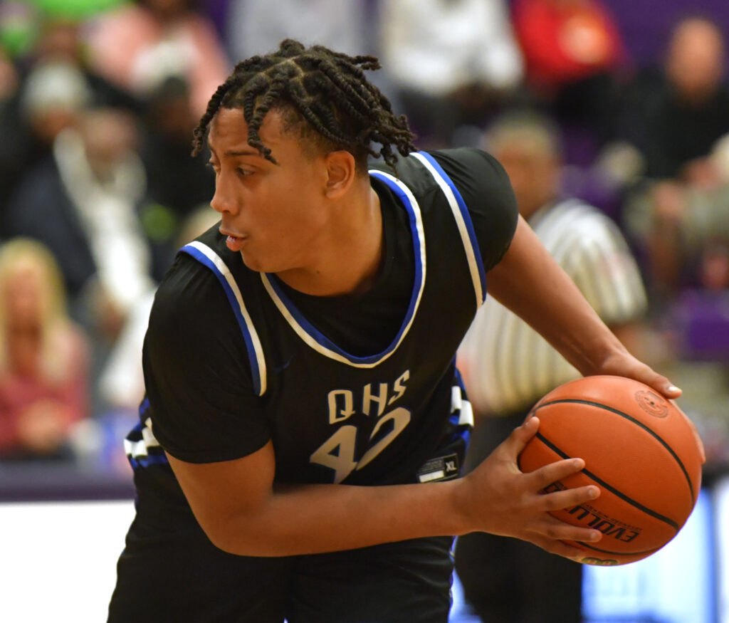 Quincy forward Keshaun Thomas shields the ball from a Collierville player. Quincy played Collierville, Tenn. in a quarterfinal game at the Collinsville Prairie Farms Holiday Classic basketball tournament at Collinsville High School in Collinsville, IL on Thursday December 29, 2022.  
Photo Courtesy Tim Vizer Photography