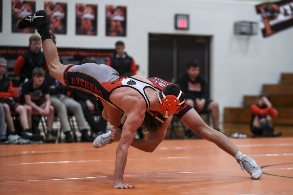 Hannibal’s Tristen Essig wrestles Palmyra’s Tyler Spicknall during their 126 pound match in the Hannibal Pirates and Palmyra Panthers dual Monday in Palmyra.  Mathew Kirby/Herald Whig-Courier Post