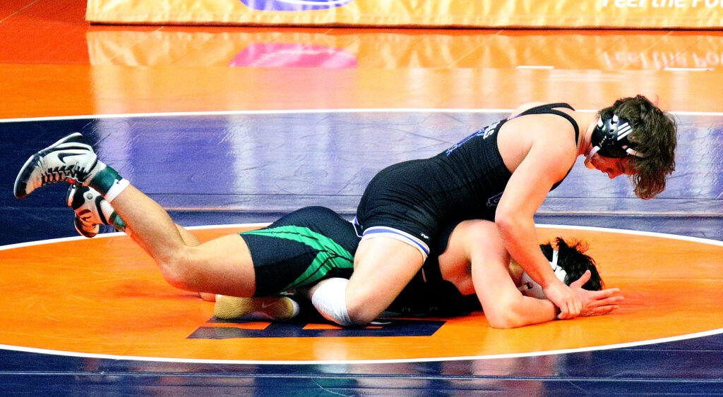 February 16, 2023 - Champaign, Illinois - 
Quincy's Owen Uppinghouse wrestles Marist's Ricky Ericksen during their Class 3A 160-pound match at the 2023 IHSA Individual Wrestling State Finals on Thursday. (Photo: PhotoNews Media/Clark Brooks)