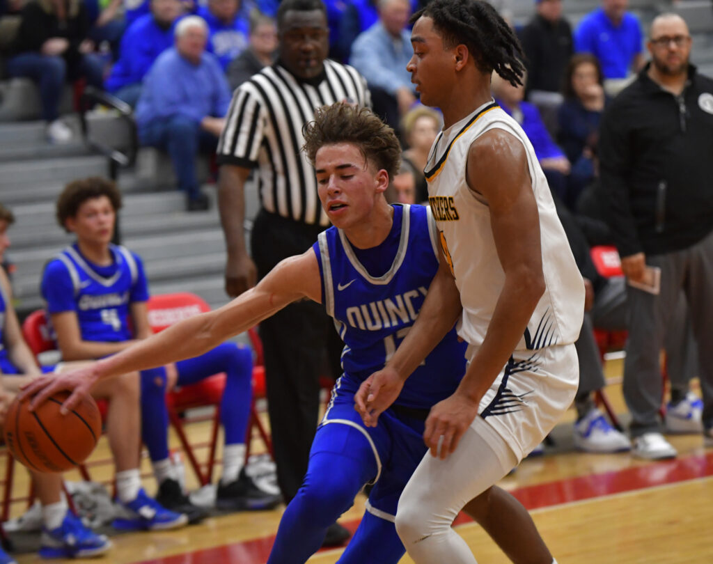 Quincy guard Bradley Longcor III dribbles around OFallon guard JalenSmith. Quincy lost to OFallon in a semifinal game of the Moline Class 4A sectional which was played at Alton High School in Alton, IL on February 28, 2023. 
Photo Courtesy Tim Vizer Photography