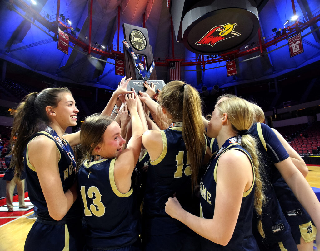 March 2, 2023 - Normal, Illinois - Members of the Quincy Notre Dame girls' basketball program celebrate with their Class 2A state trophy. (Photo: PhotoNews Media/Clark Brooks)