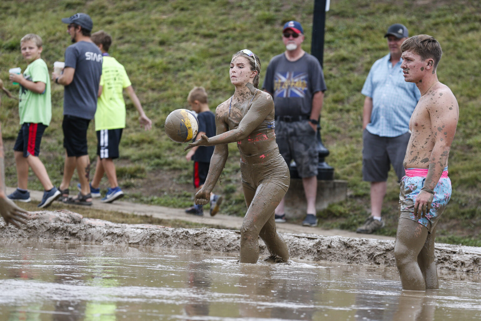 Photo gallery: Volleyball players getting knee deep in mud during 