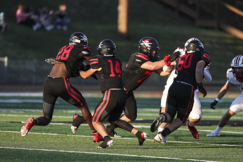 Hannibal’s Waylon Anders (14) hands the ball to Mike Ferreira (28) during the Pirates game against the Jefferson City Jays, Friday in Hannibal.  Mathew Kirby (Herald Whig/Courier Post)