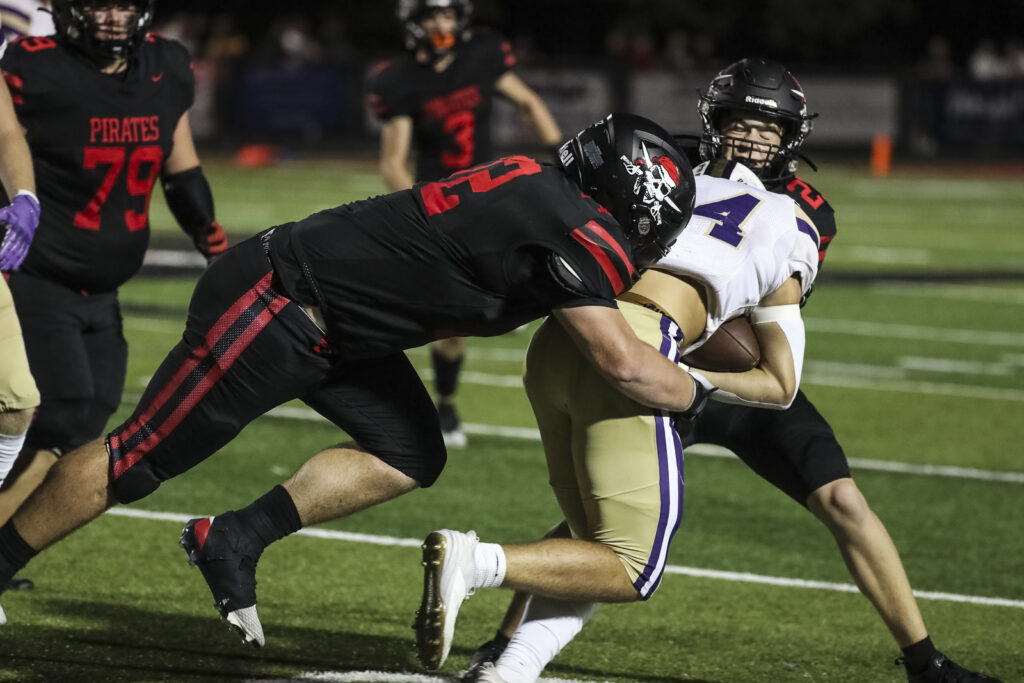 Hannibal’s Ryan Ross (72) tackles Troy’s Carter Dowel (24) during the Pirates game against the Trojans, Friday in Hannibal.  Mathew Kirby (Herald WhigCourier Post)