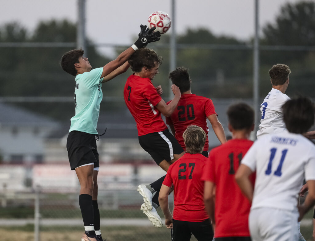 Hannibal’s Clayton Neisen (99) grabs the ball over Thomas Janes (7) during the Pirates match against the Quincy Blue Devils, Thursday in Hannibal.  Mathew Kirby (Herald WhigCourier Post)