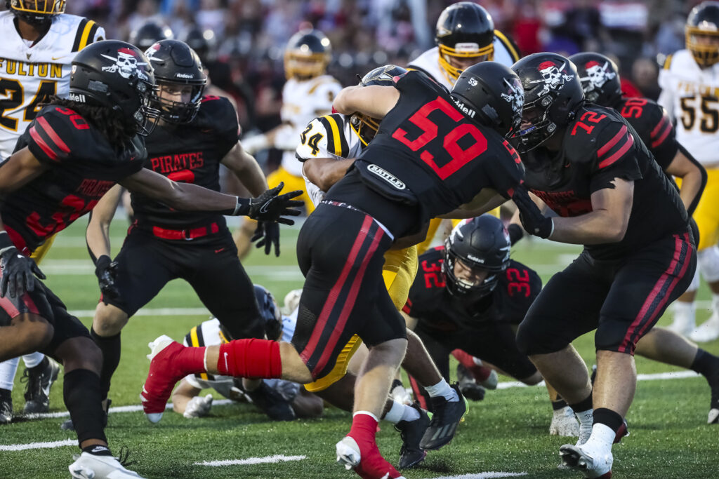 Hannibal’s Noah Young (59) tackles Fulton’s Malik Douglas (34) during the Pirates game against the Hornets, Friday in Hannibal.  Mathew Kirby (Herald WhigCourier Post)