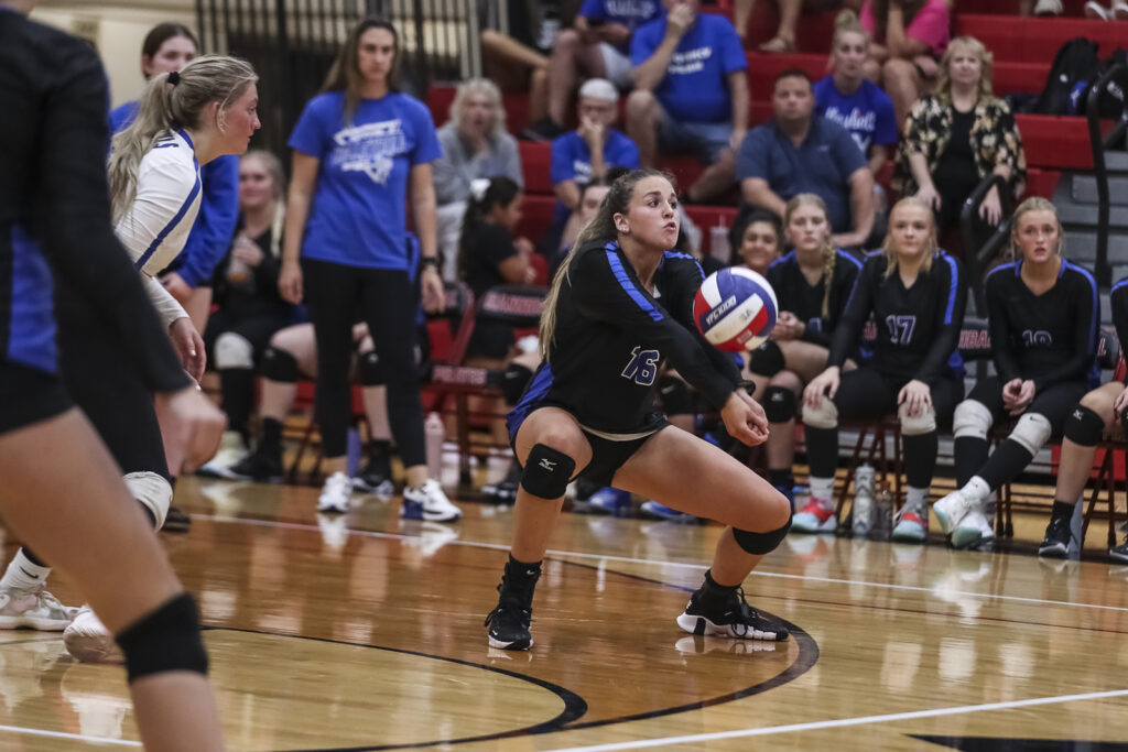 Quincy’s Kaley Summers (16) digs the ball during the Hannibal Pirates and Quincy Blue Devils match, Monday in Hannibal.  Mathew Kirby (Herald WhigCourier Post)