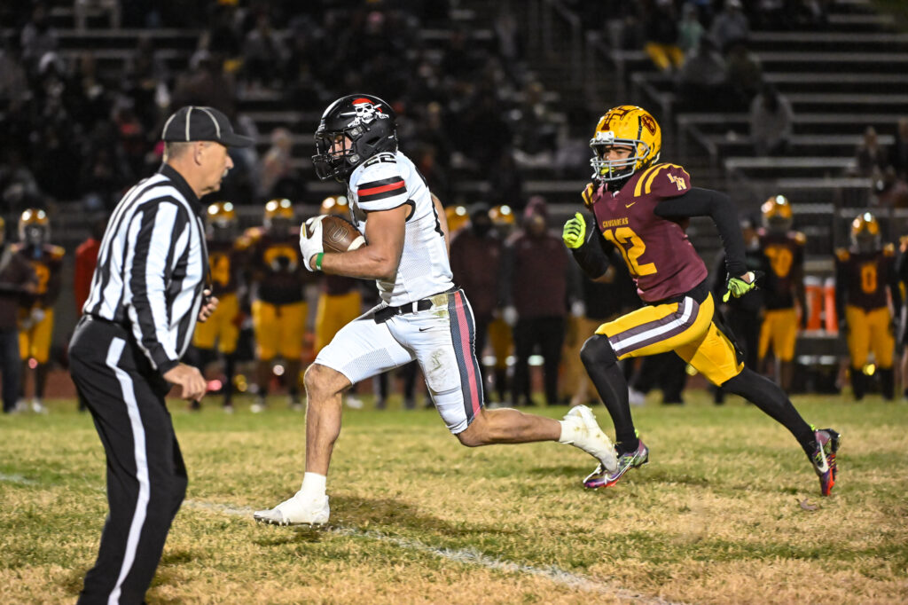 Hannibal Pirates senior Aneyas Williams (22) breaks freee away from Lutheran North Crusaders junior Xavier Chapman (12) for an early touchdown run during the class 4 State Quarterfinal game between the Hannibal Pirates and the Lutheran North Crusaders on Friday November 17, 2023 at Lutheran North High School in St. Louis County, MO  (Rick Ulreich, special to Muddyrivernews.com)