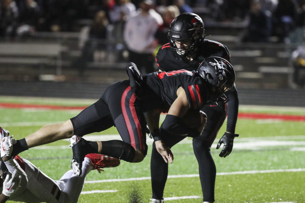 Hannibal’s Waylon Anders (14) dives into the end zone during the Hannibal Pirates district championship game against the Warrenton Warriors, Friday in Hannibal.  Mathew Kirby (Herald WhigCourier Post)