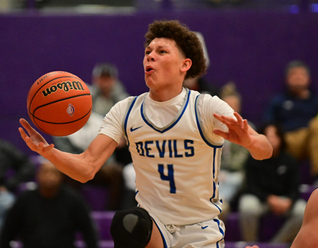 Quincy guard Camden Brown cringes in pain as he drives to the basket. Quincy defeated Oakville in a first-round game at the Collinsville Prairie Farms Holiday Classic at Collinsville High School on Wednesday December 27, 2023. 
Photo by Tim Vizer for Muddy River Sports