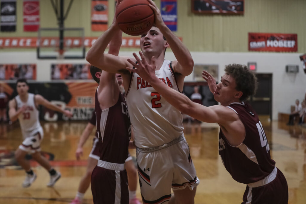 Palmyra’s Bear Bock (2) spits two defenders for a shot during the Tony Lenzini basketball tournament championship game the Canton Tigers and the Palmyra Panthers, Saturday in Palmyra.  Mathew Kirby (Herald WhigCourier Post)
