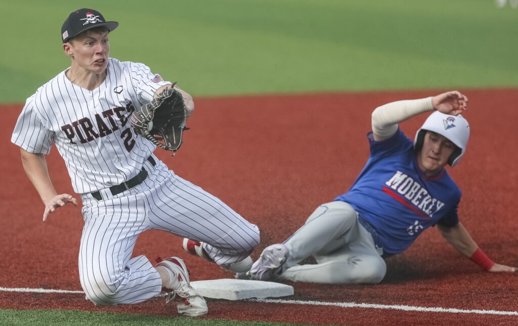 330A9868 Hannibal third baseman Jaxon Lay (20) catches a ball during the Pirates game against the Moberly Spartans, Monday in Hannibal. Mathew Kirby (Herald WhigCourier Post)