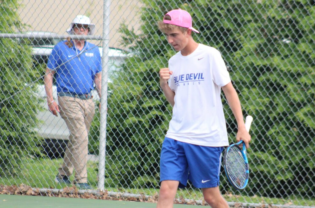 Quincy High School sophomore Kael Holzgrafe celebrates winning a point during Monday's No. 1 doubles match in Quincy's dual against Quincy Notre Dame at at Reservoir Park.